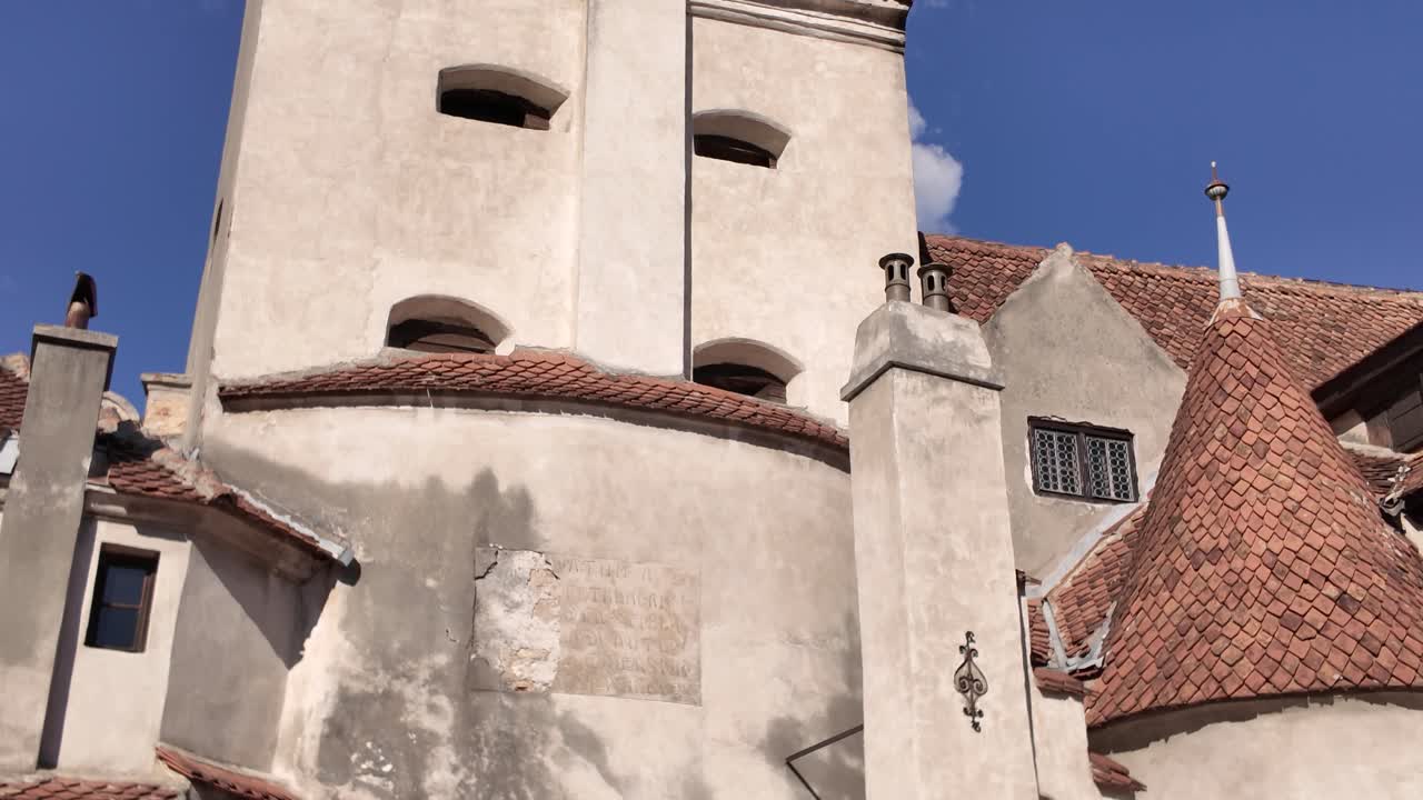 Detailed view of the inner courtyard walls of Bran Castle, highlighting stone textures and wooden architectural elements