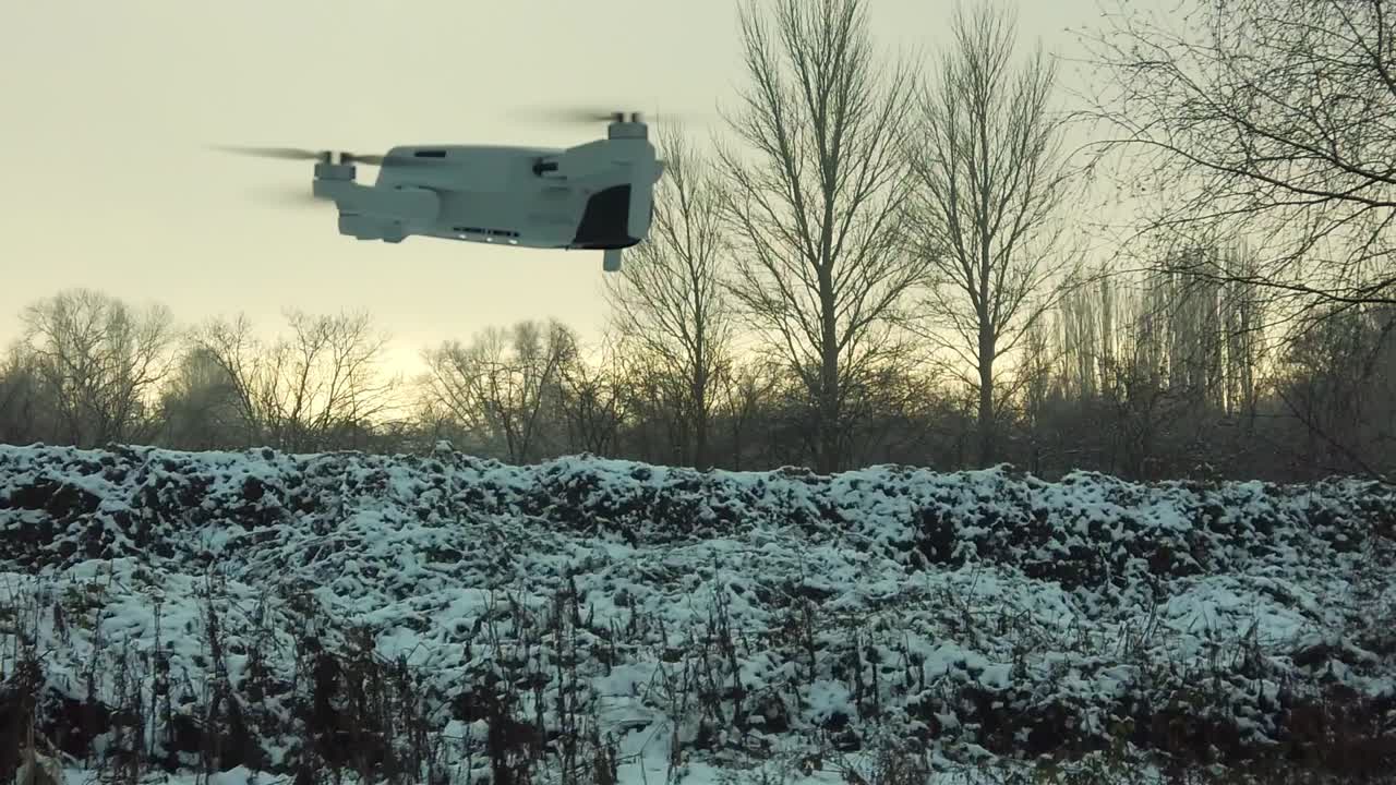 DJI drone in-flight on snowy field in Winter