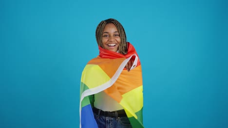 smiling young black woman with rainbow pride flag