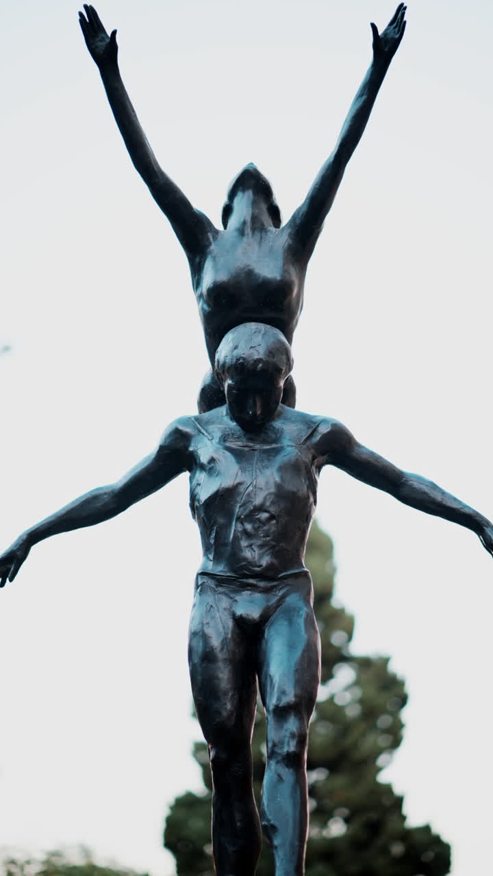 Bronze statue of a man and a woman dancing in a park in Monte Carlo, Monaco. Vertical
