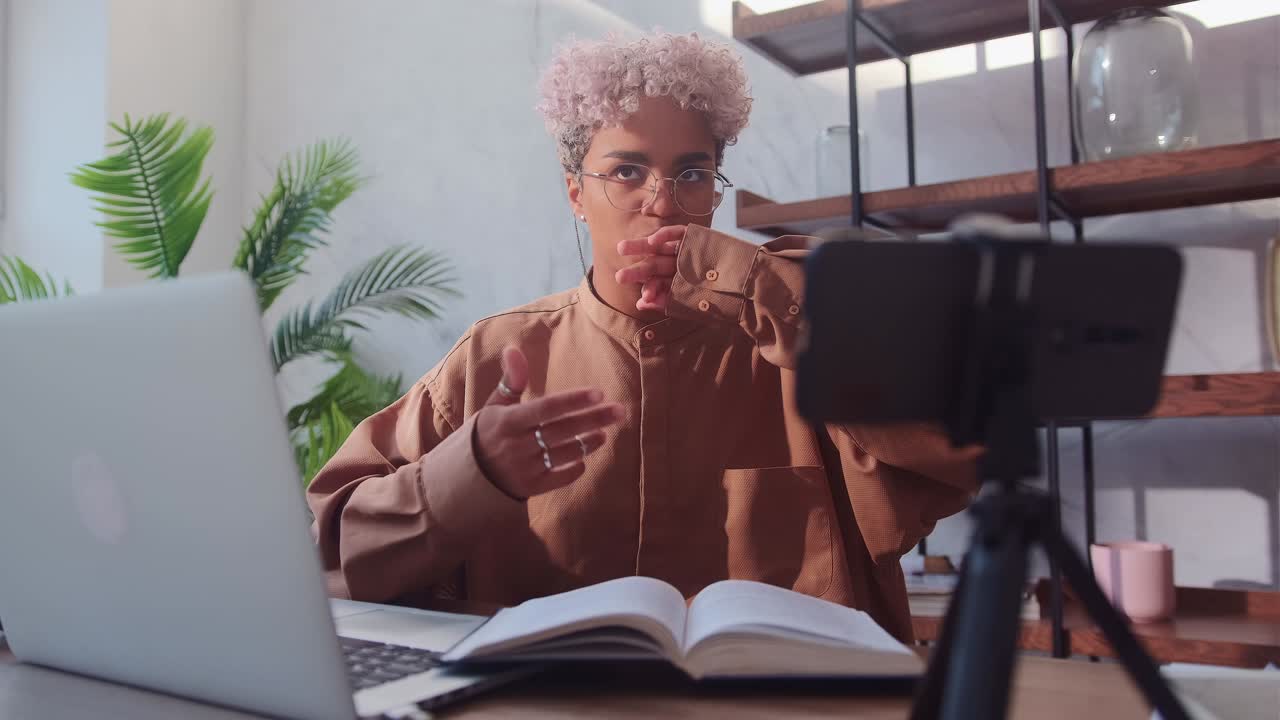 Young friendly african american woman is recording her video blog