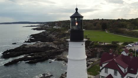 beautiful lighthouse on maine coastline, parallax aerial shot