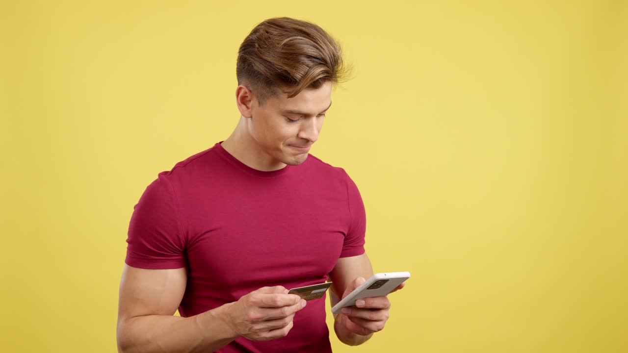 Man using a credit card and smartphone for online shopping