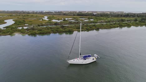 orbital shot of sailboat with lifeboat in florida wetlands