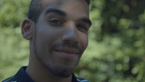 confident man looking at camera, being serious, touching chin