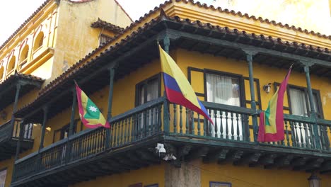 cartagena and colombia waving flags against a backdrop of historic architecture, heritage and national pride