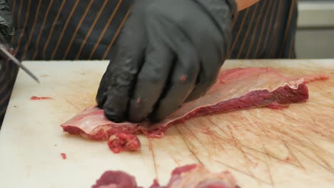 chef cutting raw beef