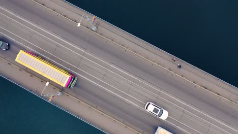 aerial view. two-way traffic on the bridge over the river. close-up of city traffic