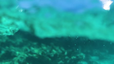 beautiful blue water texture with bubbles,  above and under water, splash in slow motion