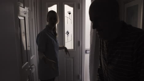 caregiver visiting elderly patient at home