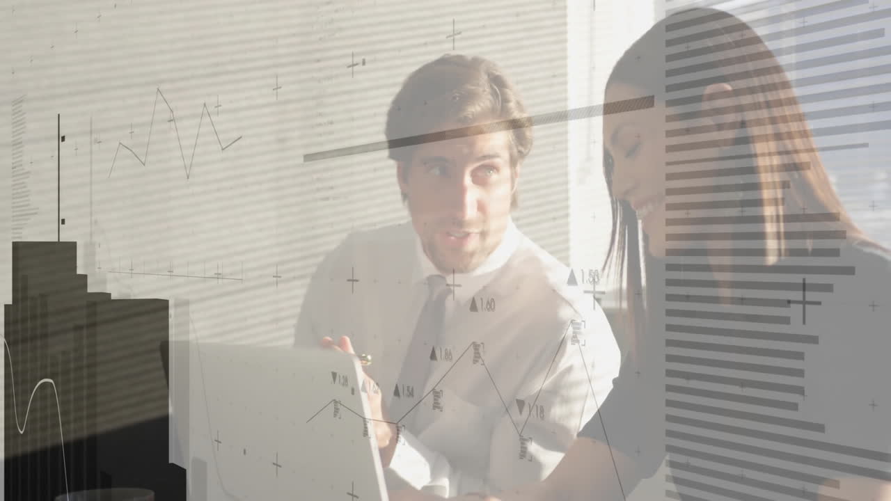 Coworkers collaborating over laptop in modern office, showing animated business graphs and charts