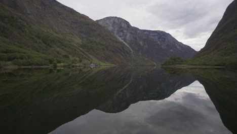 steady footage of a beautiful fjord on calm morning with the reflection of mountains on the water