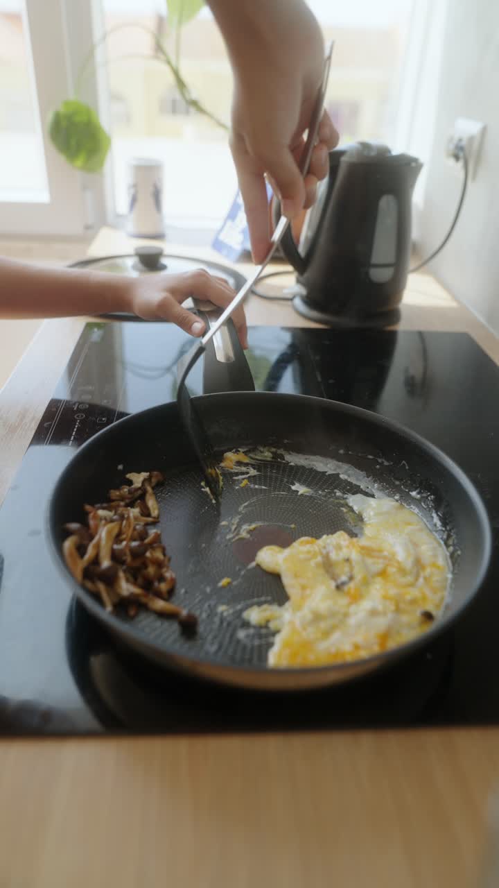Frying Eggs and Mushrooms in a Pan