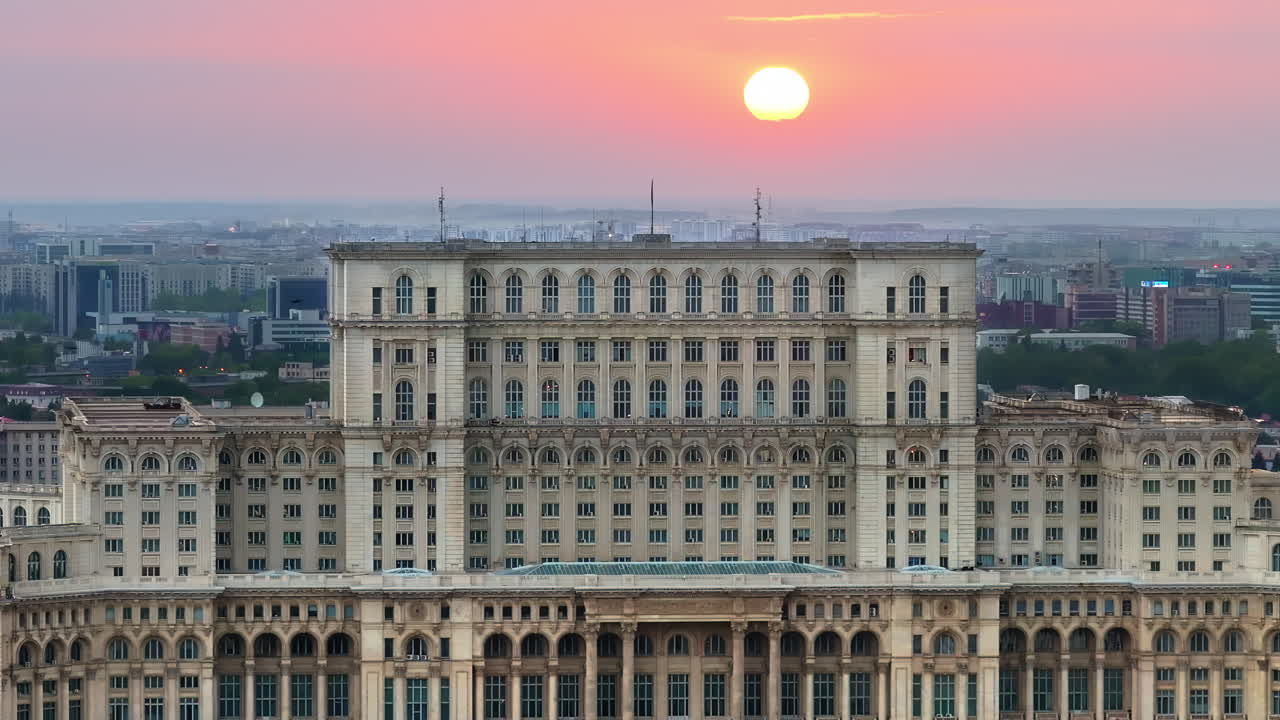 Aerial drone view of the Palace of Parliament in Bucharest, Romania at sunset