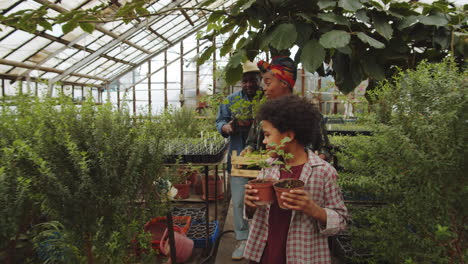 African-American-Family-Carrying-Plants-through-Greenhouse