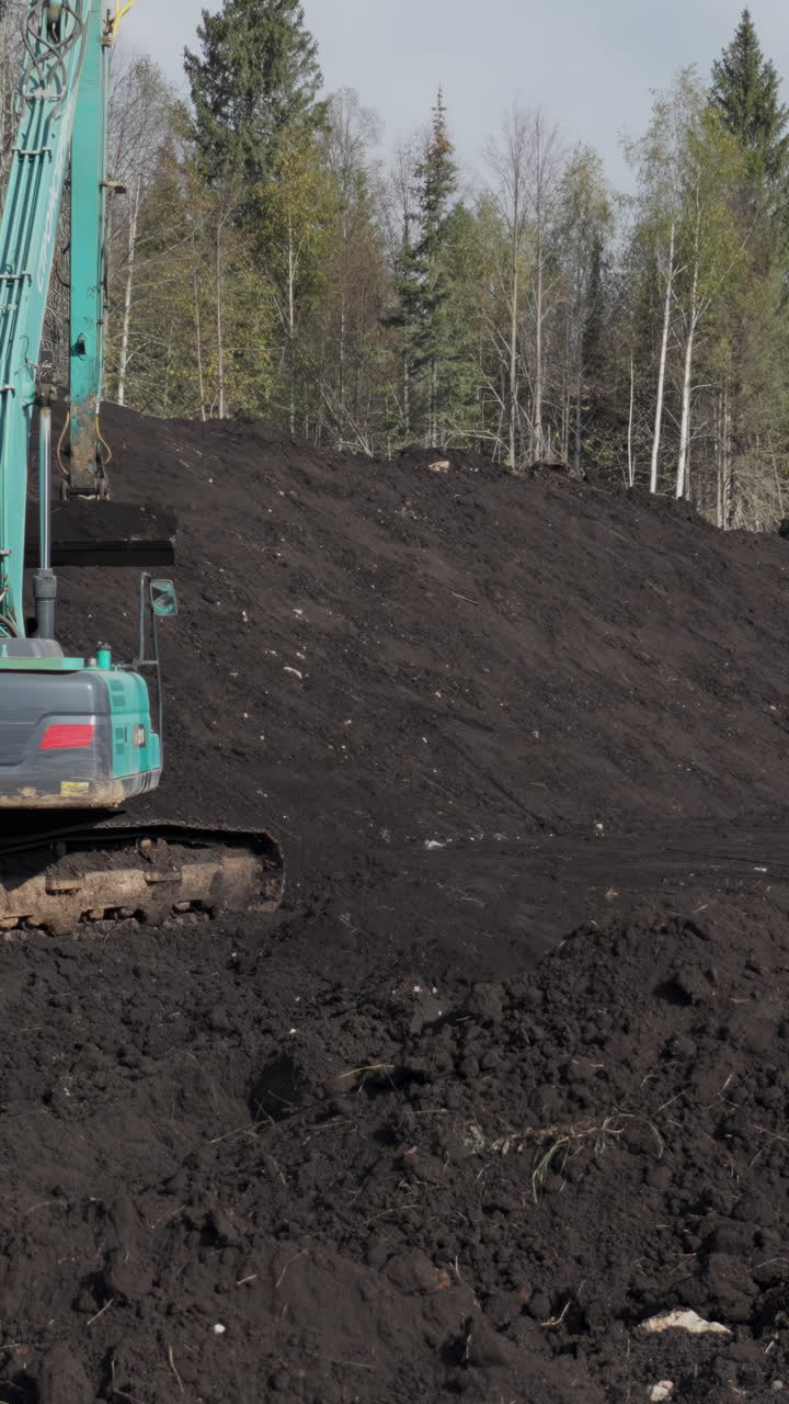 Excavator working on a dirt hill