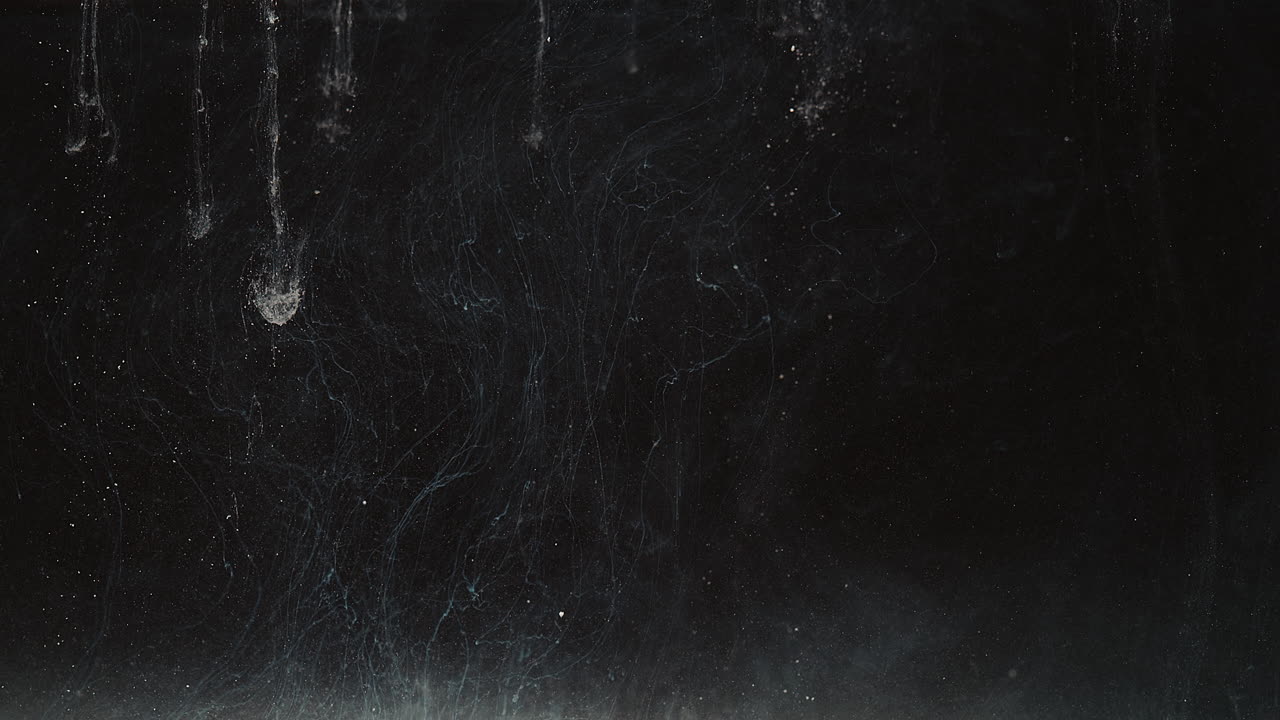 partículas líquidas blancas suben y bajan en el espacio negro, resumen