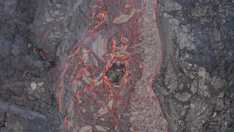 flowing lava river from a volcano eruption in south iceland -top view