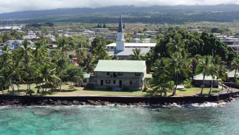 aerial close-up panning shot of historic hulihe'e palace on the shores of kailua-kona, hawai'i