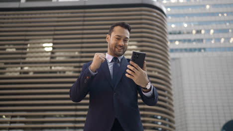 amazed happy businessman receiving sms message reading good news