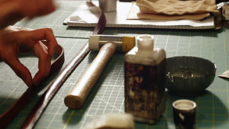 craftswoman preparing leather belt