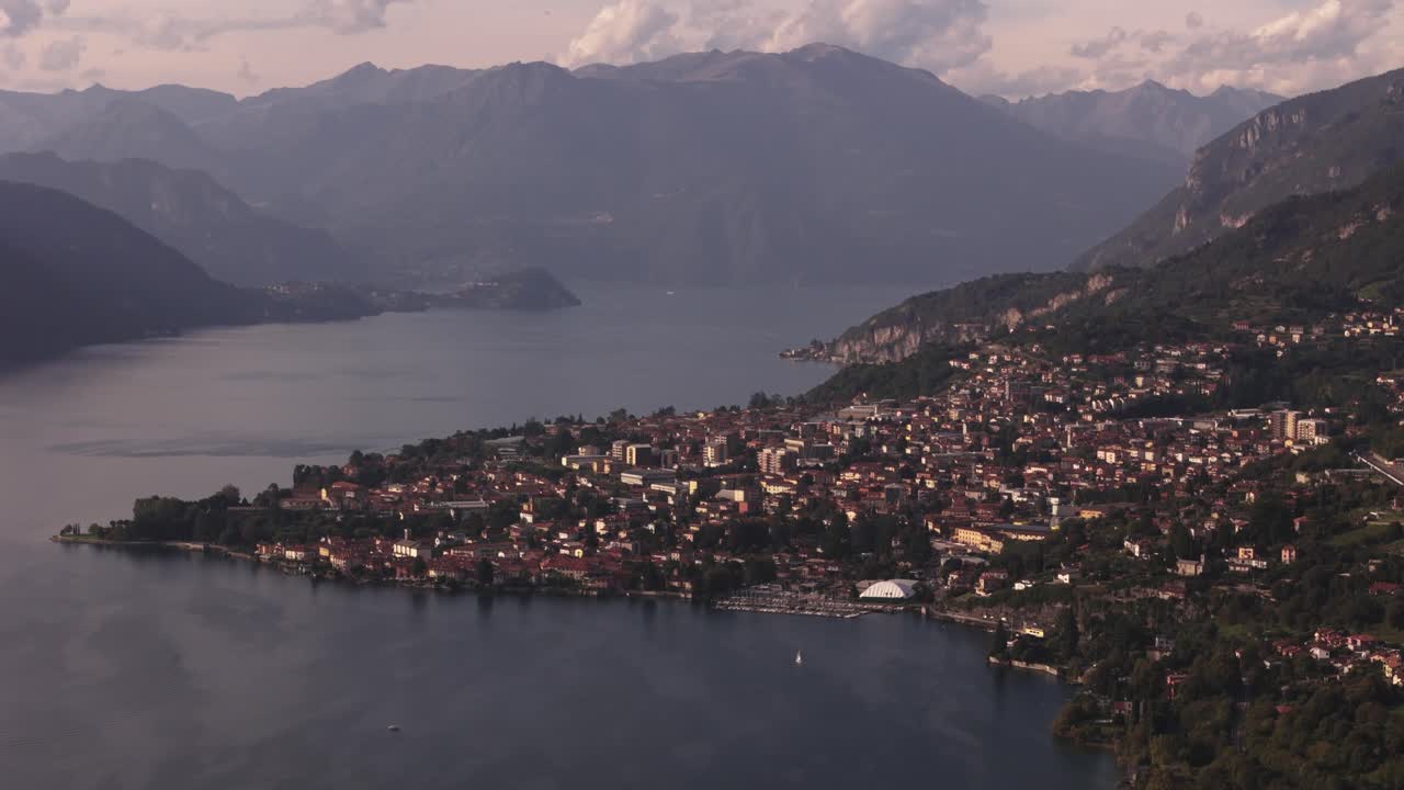 Cinematic drone view ofMandello del Lario, mountains in background, Lake Como, Italy