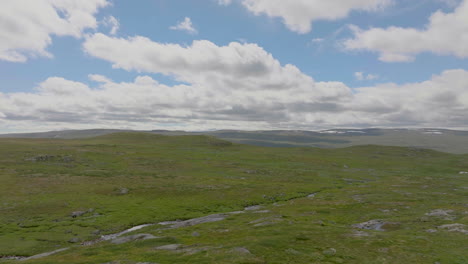 aerial view over hardanger plateau with wild green landscape, beautiful sky