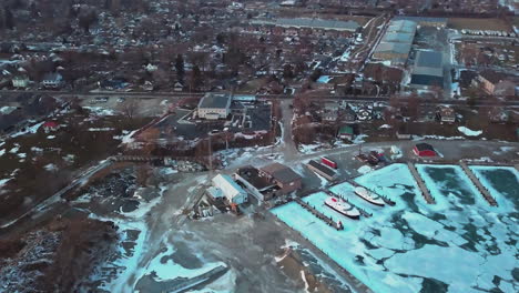 sweeping shot over a stone quarry and a dock surrounded by ice from the frozen lake