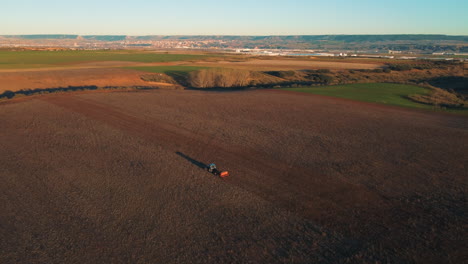 aerial view of tractor cultivating farmland