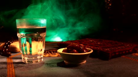 water and dates. iftar is the evening meal. slider view of decoration ramadan kareem holiday. festive greeting card, invitation for muslim holy month ramadan kareem. dark background. selective focus