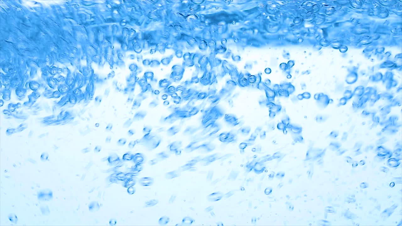 Water with a mixer whisk, slow-motion shooting.