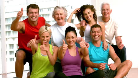 fitness class showing thumbs up