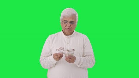 Indian-old-man-counting-money-Green-screen