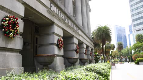 flower baskets hanging on a city building's facade.