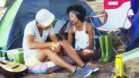 Couple-interacting-with-each-other-while-having-bottle-of-beer-4k