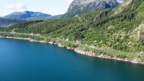 aerial view of norwegian scenic route helgelandskysten with vehicles driving in northern norway