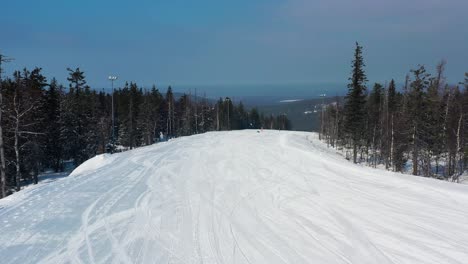 snowy ski slope in a mountain forest