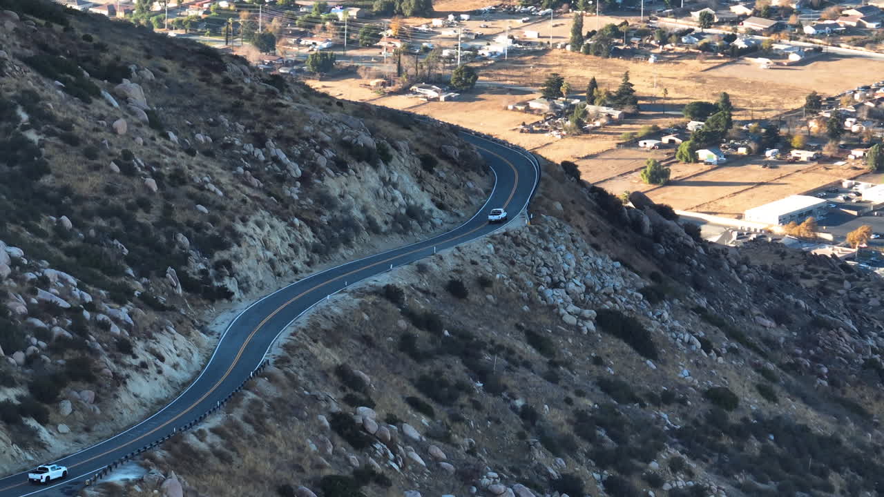 Aerial view following a traffic on the San Bernardino pass in sunny Los Angeles