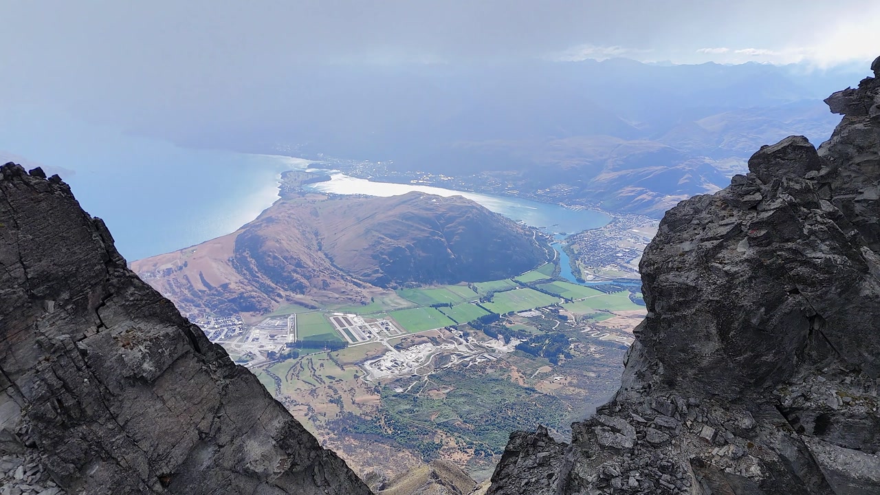 Fly through mountain summit cleft to reveal Queenstown, New Zealand