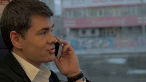 man having business call in the train