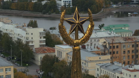 cityscape with gold star monument