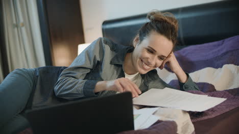 happy woman working with documents at home. smiling woman doing paperwork