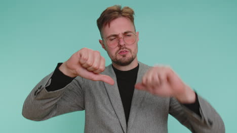 upset business man in jacket showing thumbs down sign gesture, disapproval, dissatisfied dislike