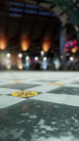 close-up view of the yellow and black tiled floor of a metro station