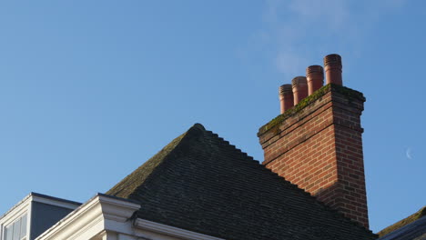 Smoke-Coming-Out-Of-Chimney-On-Roof-Of-House