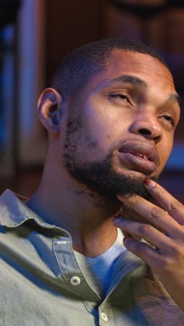 vertical video black teleworker thinking about ways to improve his productivity