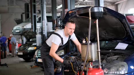 mechanic working on a car engine in an auto repair shop