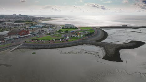 seaside town morecambe grassy headland with stone groynes and pier. eden project proposed site. summer. marine road central, morecambe, lancashire, uk