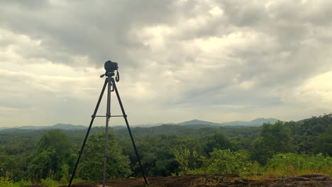 A-camera-is-set-on-a-tripod-to-shoot-a-time-lapse,-on-a-mountain-top