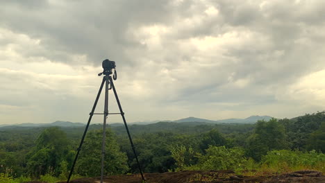 a camera is set on a tripod to shoot a time lapse, on a mountain top